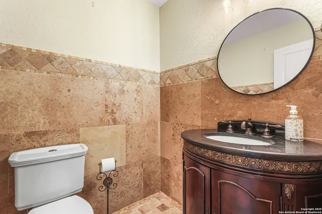 a bathroom with a toilet a sink and a mirror