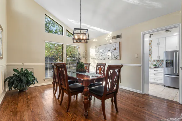 a view of a dining room with furniture window and wooden floor