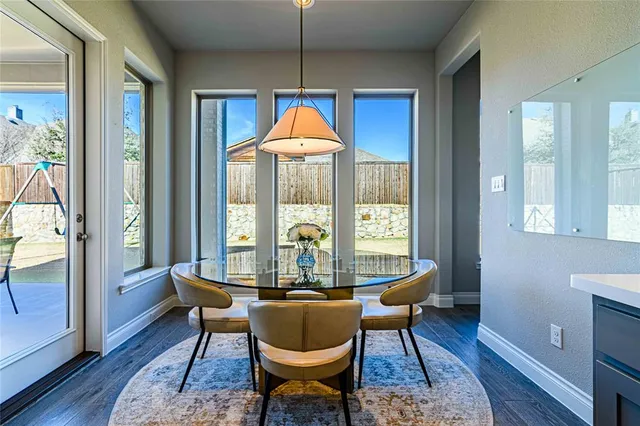 a dining room with furniture a chandelier and wooden floor