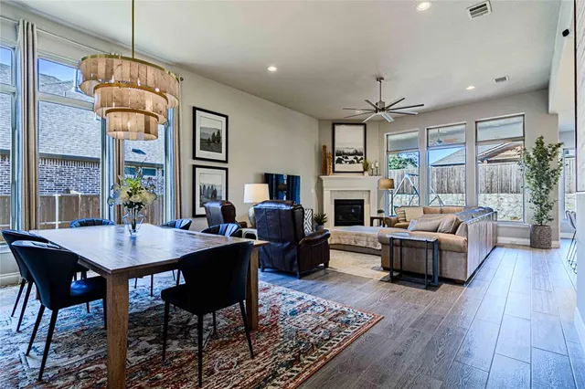 a living room with furniture a dining table and a fireplace
