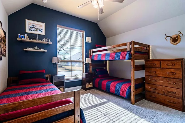 a bedroom with furniture and a lamp