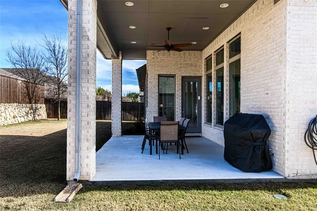 a view of a patio with dining table and chairs with wooden floor