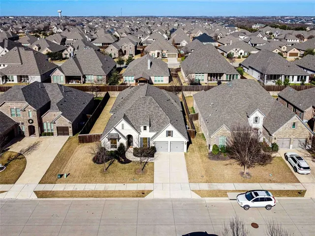 an aerial view of a house with a swimming pool