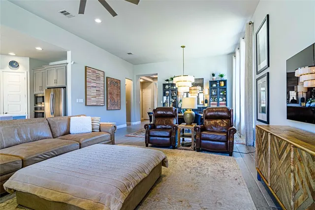 a bedroom with furniture and a large window