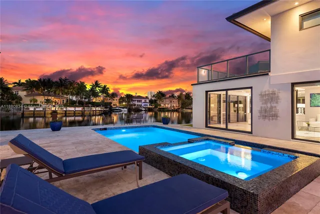 a swimming pool view with a seating space and garden space