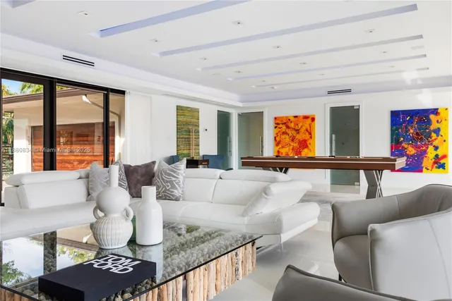 a living room with furniture a fireplace and a large window