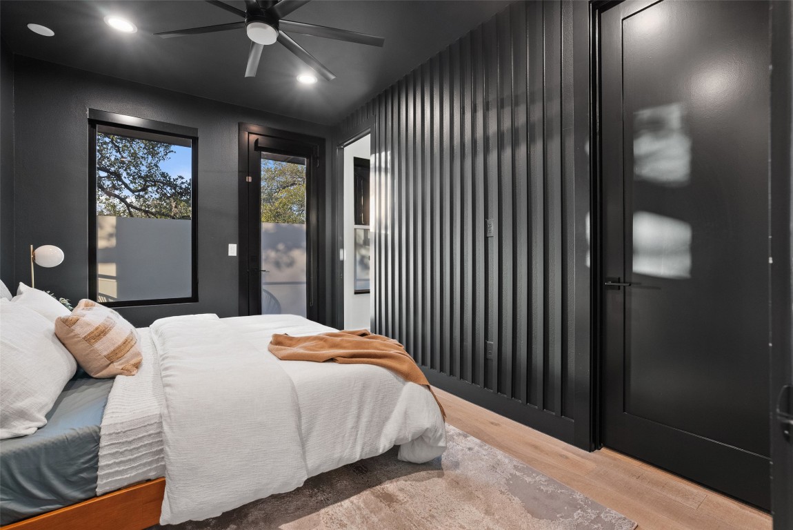 2209 Rae Dell Avenue Austin, TX 78704 - Photo 13 of 33 a bedroom with a large bed and a chandelier