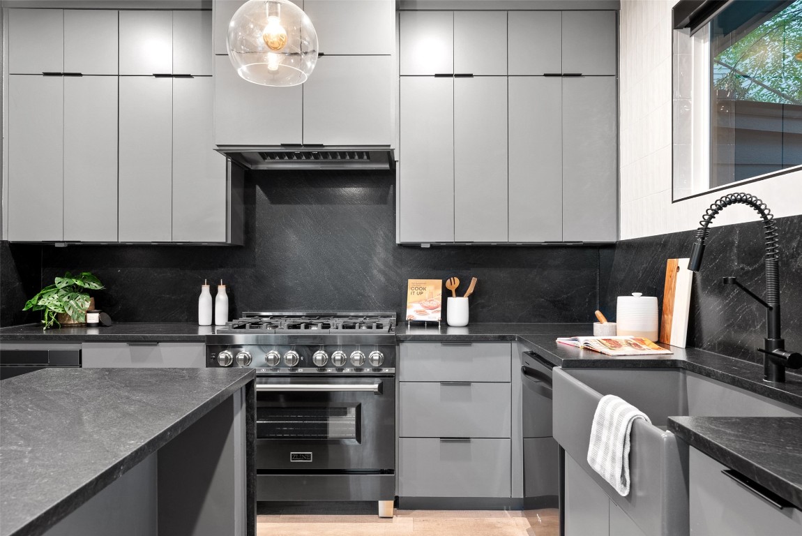 2209 Rae Dell Avenue Austin, TX 78704 - Photo 7 of 33 a kitchen with stainless steel appliances granite countertop a sink a stove and a microwave