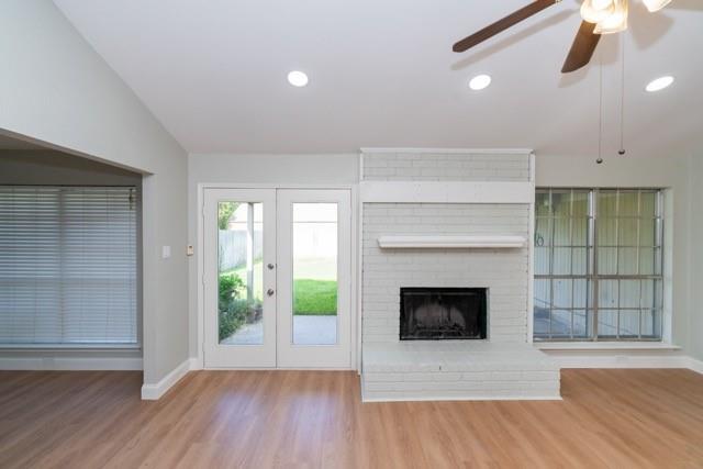 106 Mapleleaf Lane Coppell, TX 75019 - Photo 5 of 36 Living area featuring wood-finish flooring, a painted brick fireplace with a mantel, recessed lighting, and a ceiling fan