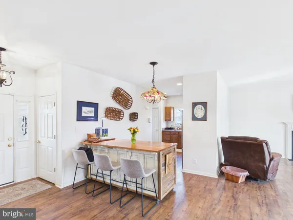 a dining room with furniture and wooden floor