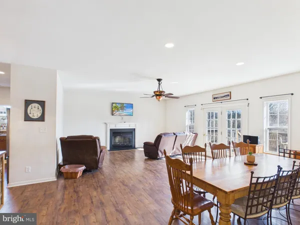 a dining room with furniture and wooden floor