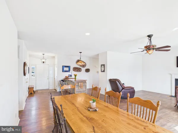 a living room with furniture a dining table and a fireplace