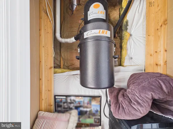 a bedroom with a bed a chandelier and dresser