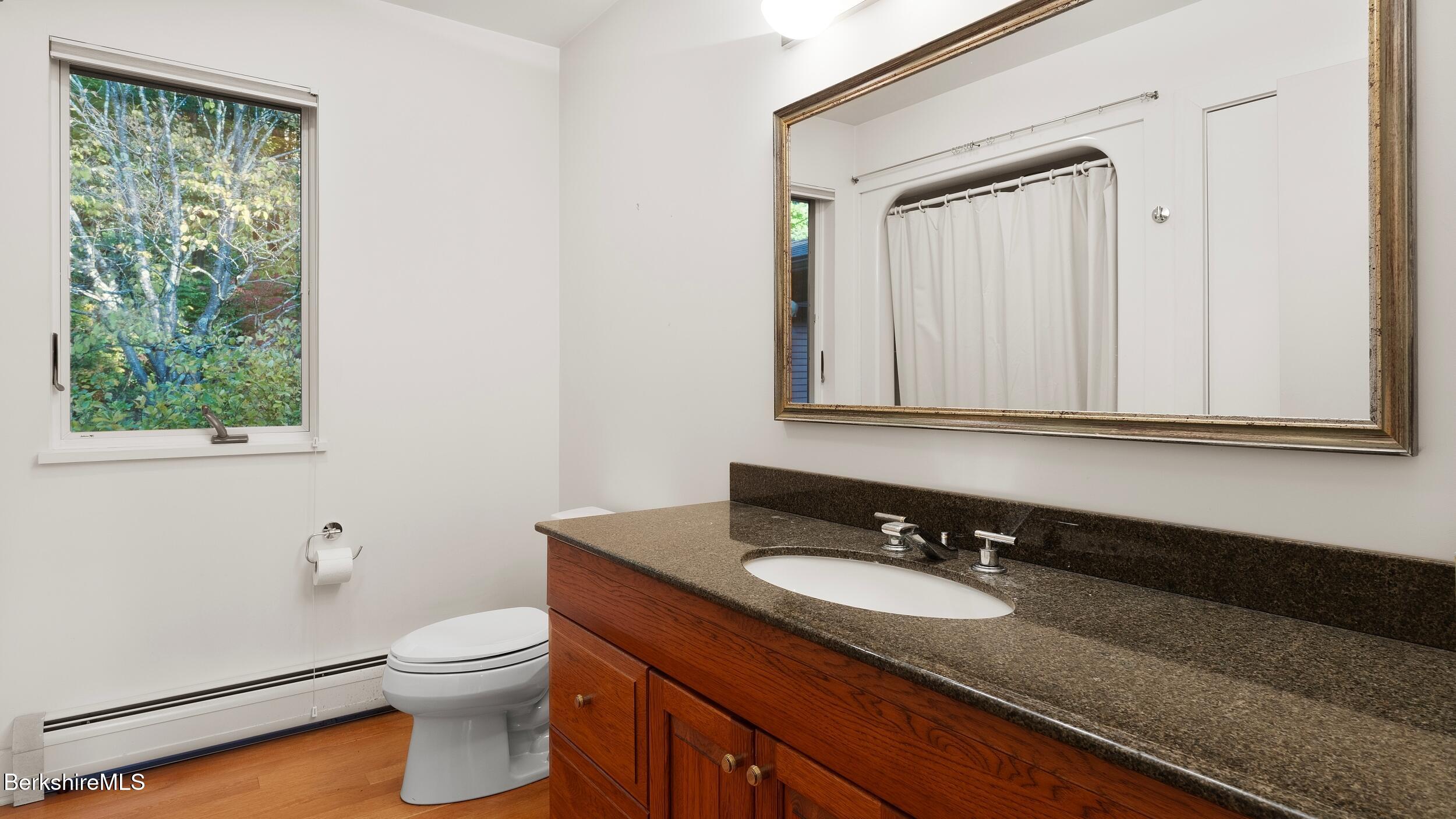 297 E Road Alford, MA 01266 - Photo 27 of 45 a bathroom with a granite countertop sink toilet and mirror