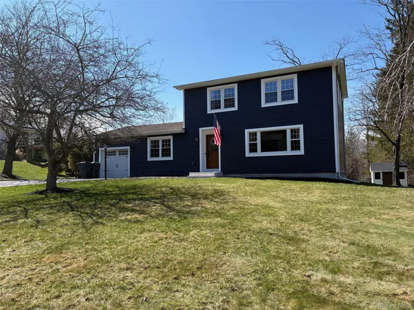 a front view of a house with outdoor seating