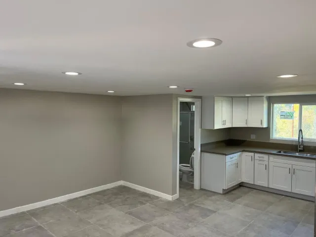a kitchen with a sink and white cabinets