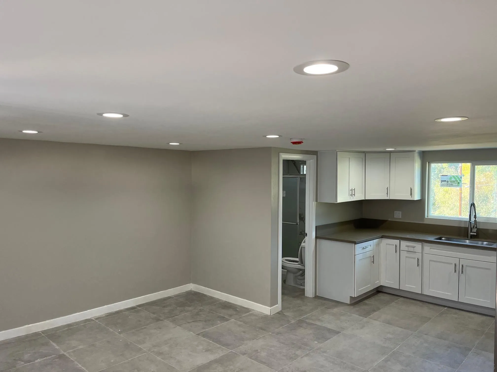 1404 Jamacha Road El Cajon, CA 92019 - Photo 3 of 12 a kitchen with a sink and white cabinets