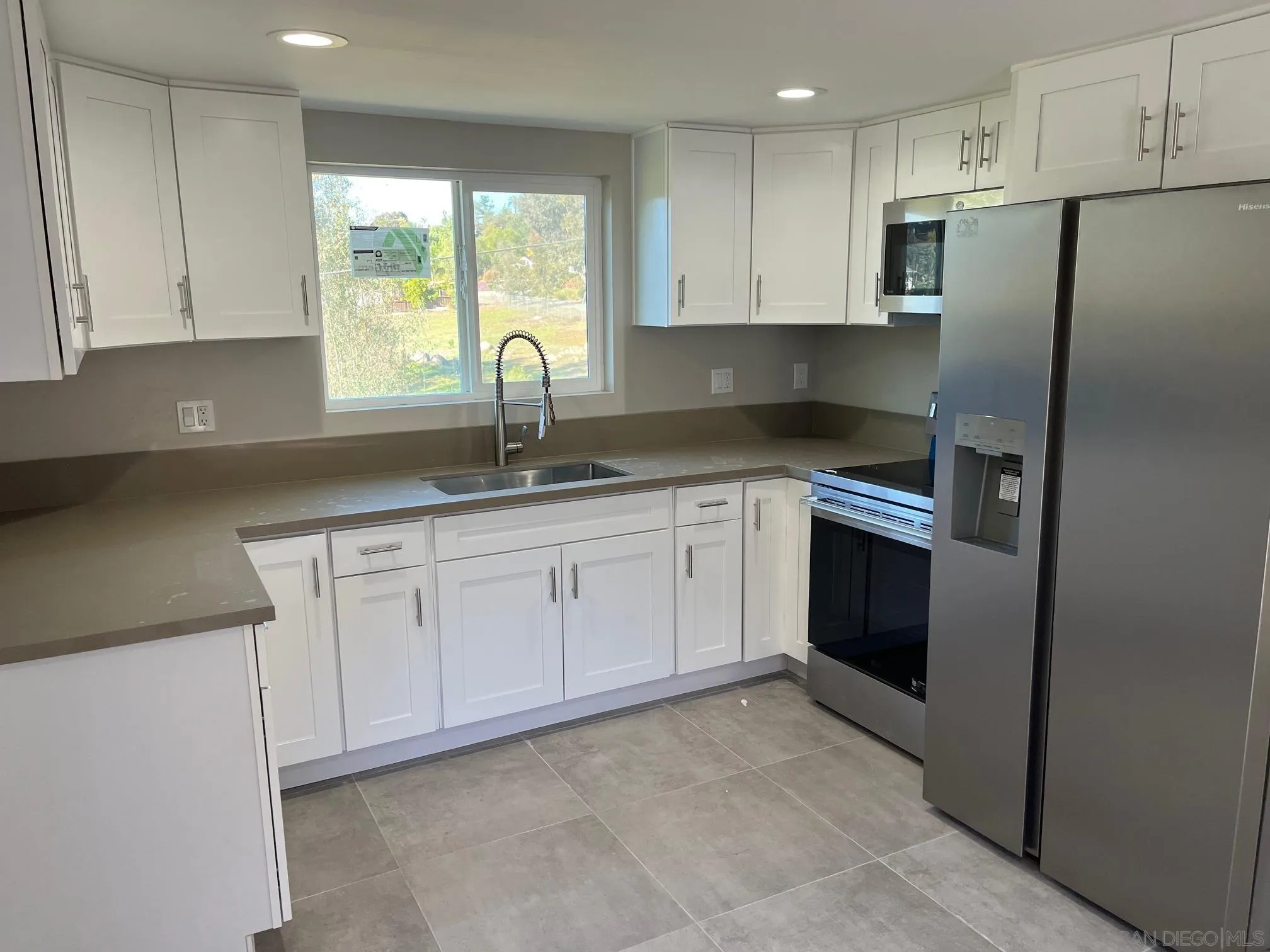 1404 Jamacha Road El Cajon, CA 92019 - Photo 4 of 12 a kitchen with stainless steel appliances granite countertop a refrigerator sink and cabinets