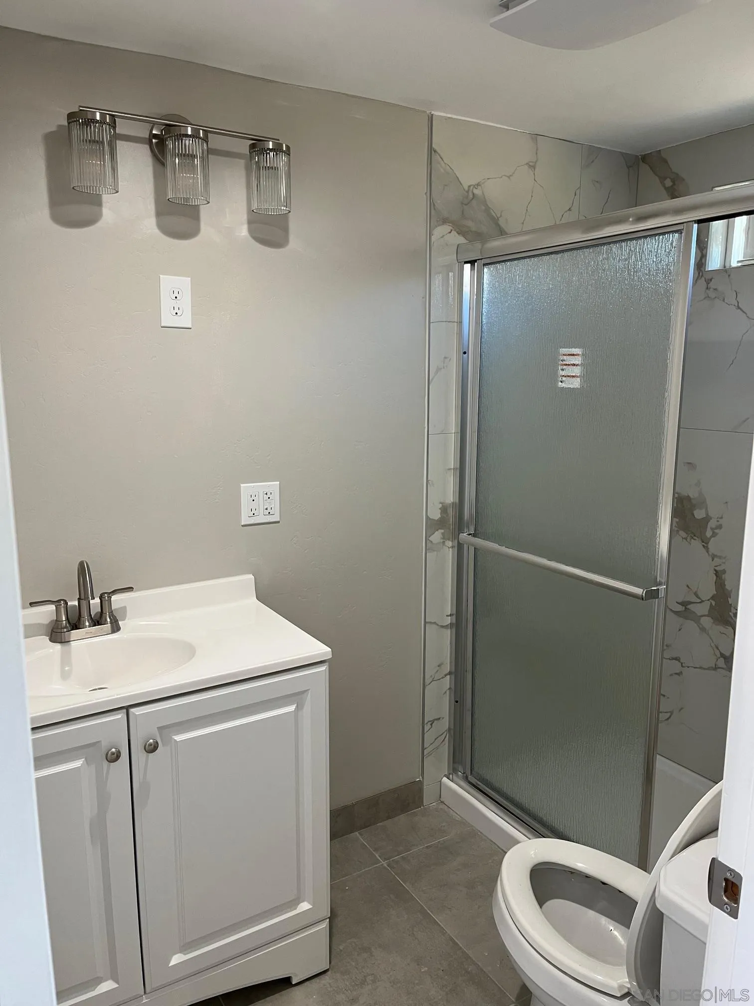 1404 Jamacha Road El Cajon, CA 92019 - Photo 6 of 12 a bathroom with a sink a toilet and shower