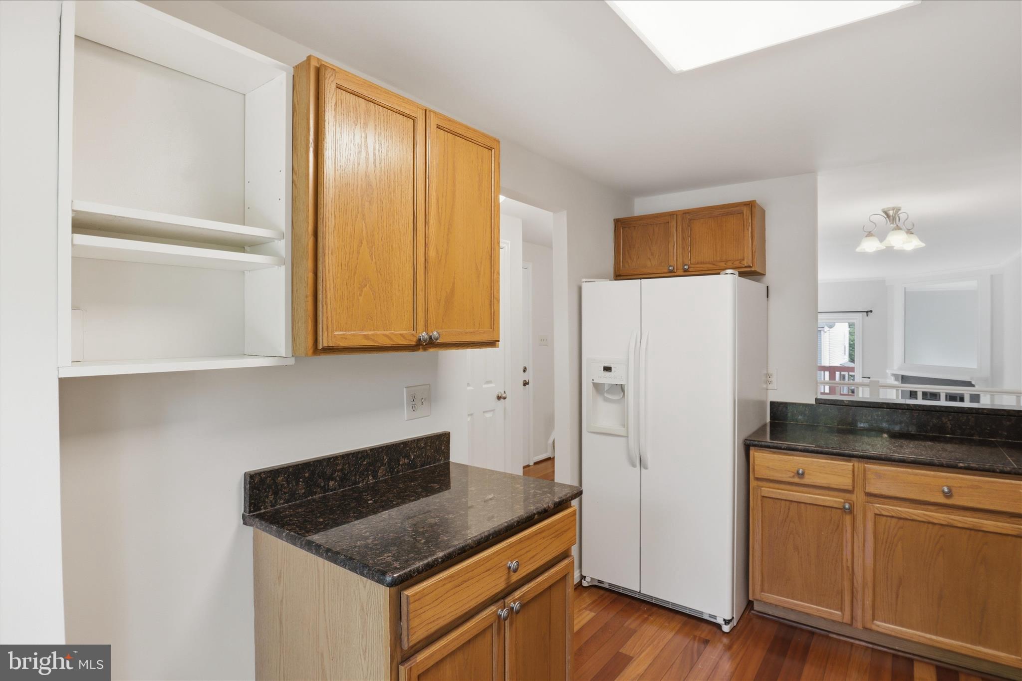 1773 Whisperhill Drive Reston, VA 20194 - Photo 18 of 51 a kitchen with granite countertop cabinets and refrigerator