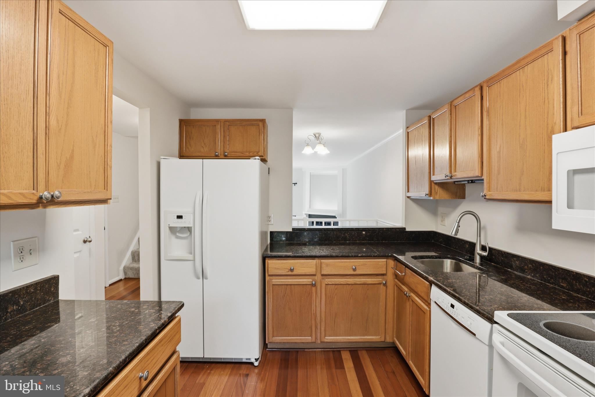 1773 Whisperhill Drive Reston, VA 20194 - Photo 20 of 51 a kitchen with a sink a refrigerator and cabinets