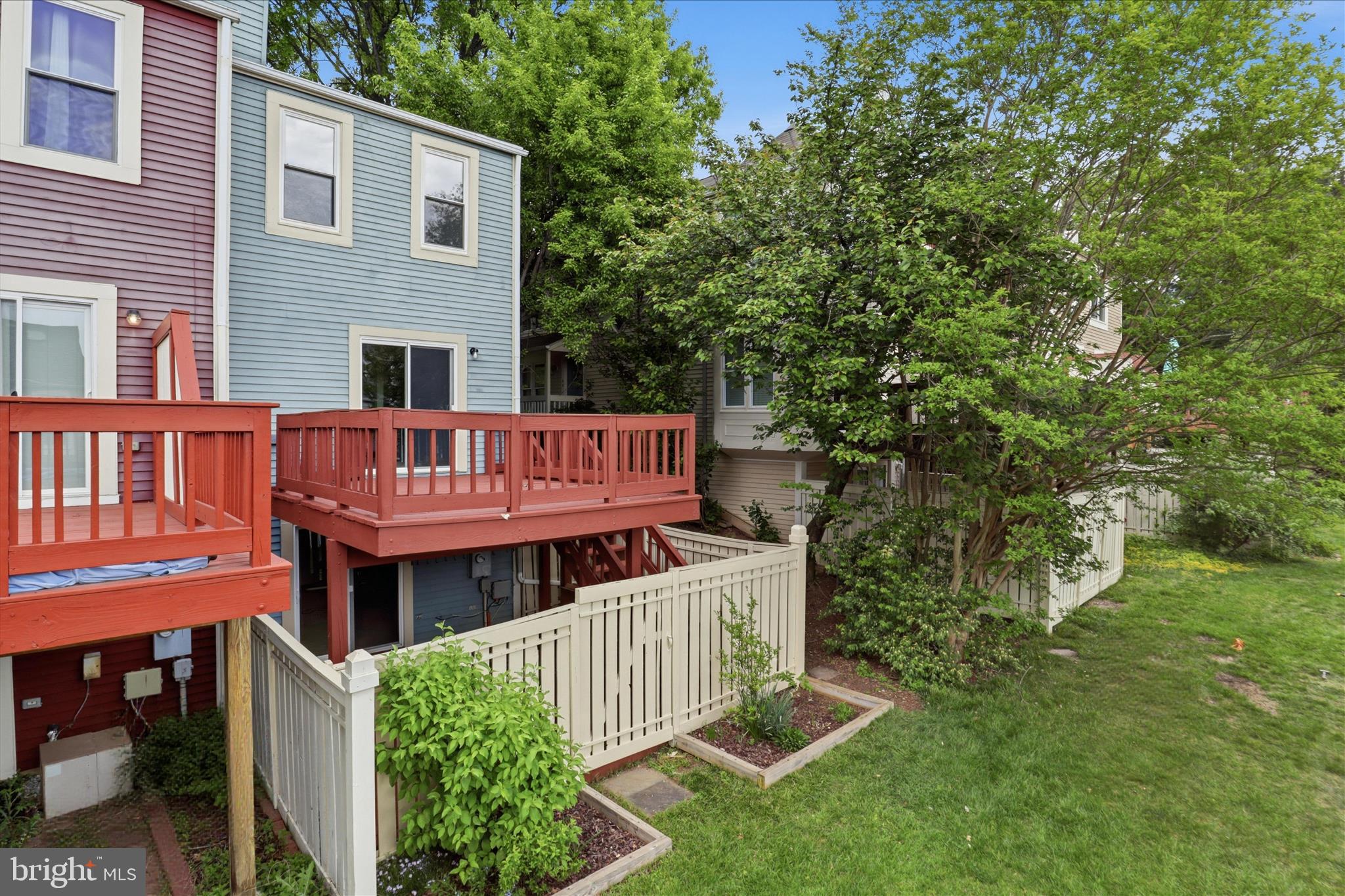 1773 Whisperhill Drive Reston, VA 20194 - Photo 42 of 51 a view of a house with a wooden deck and a yard