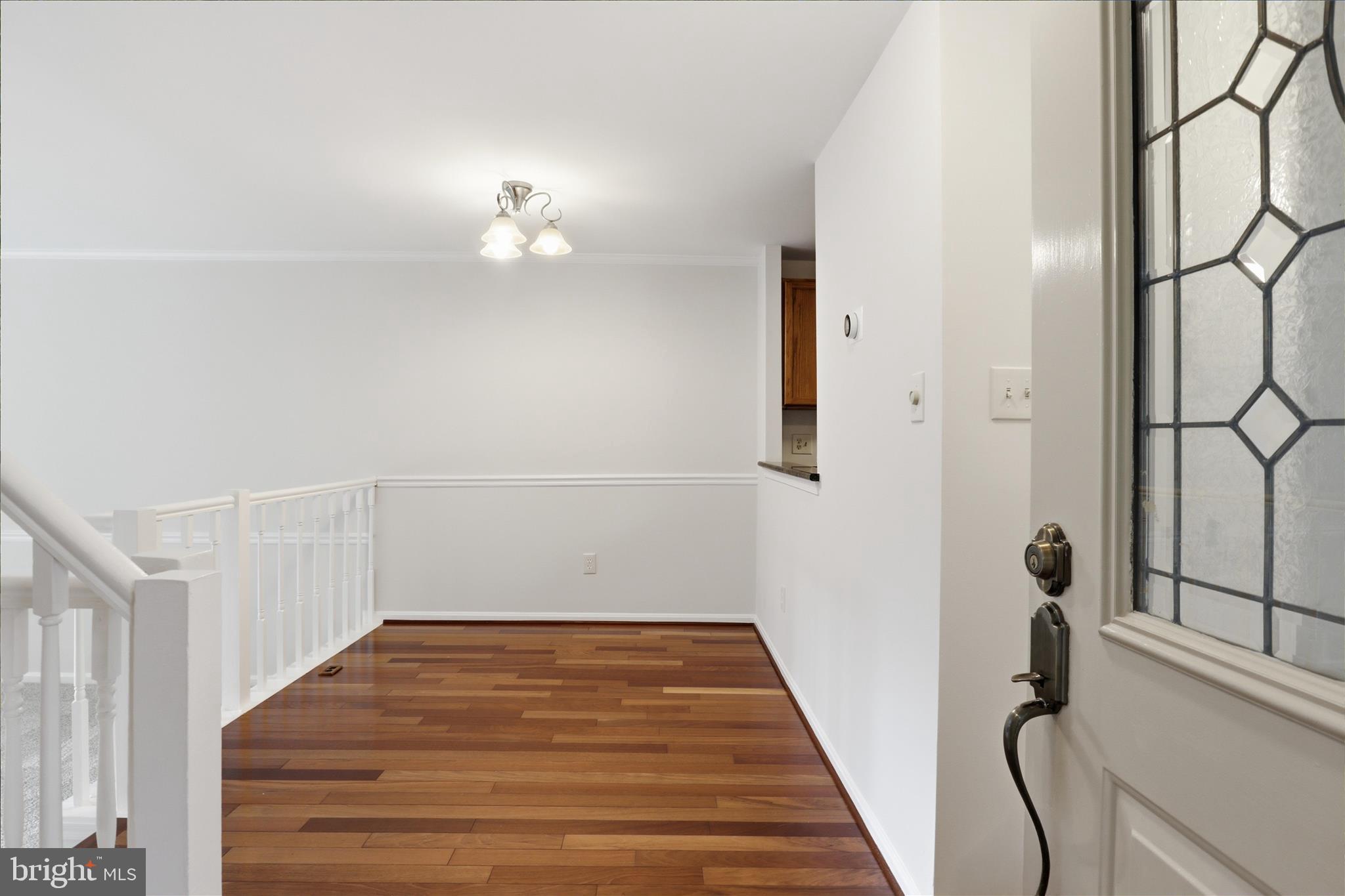 1773 Whisperhill Drive Reston, VA 20194 - Photo 6 of 51 a view of a hallway with wooden floor and staircase