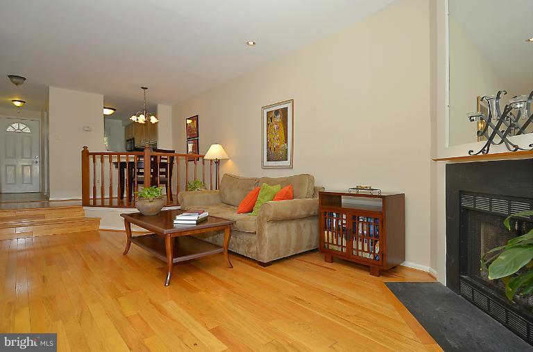 1688 Oaktree Court Reston, VA 20194 - Photo 1 of 23 a living room with furniture and a fireplace