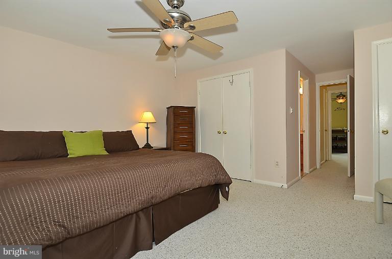 1688 Oaktree Court Reston, VA 20194 - Photo 2 of 23 a bedroom with a bed and a ceiling fan