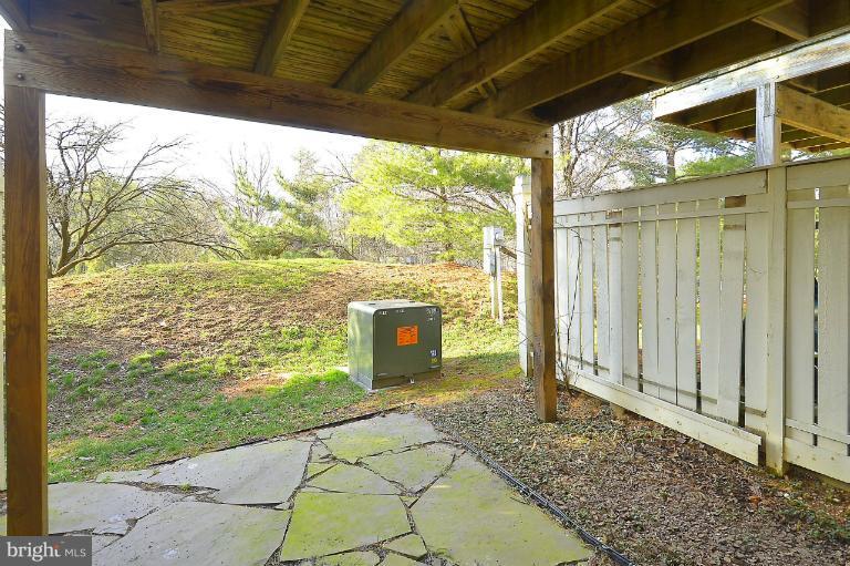1688 Oaktree Court Reston, VA 20194 - Photo 14 of 23 a view of a porch with a table and chairs next to a yard