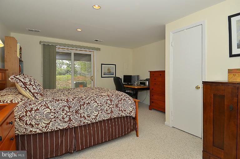 1688 Oaktree Court Reston, VA 20194 - Photo 16 of 23 a bed sitting in a bedroom next to a window