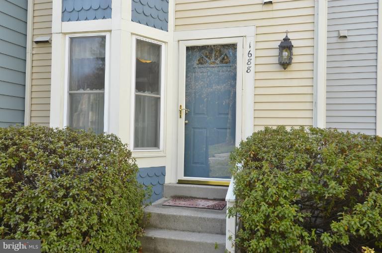 1688 Oaktree Court Reston, VA 20194 - Photo 17 of 23 a front view of a house with a garden