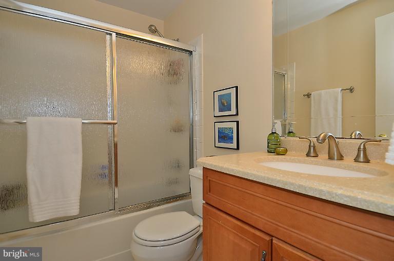 1688 Oaktree Court Reston, VA 20194 - Photo 20 of 23 a bathroom with a granite countertop sink toilet and shower