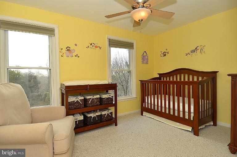 1688 Oaktree Court Reston, VA 20194 - Photo 4 of 23 a bedroom with a bed and a chandelier