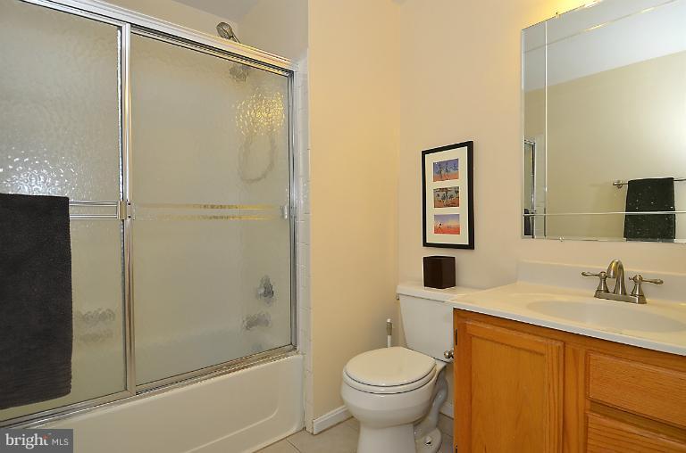 1688 Oaktree Court Reston, VA 20194 - Photo 10 of 23 a bathroom with a granite countertop sink toilet and shower