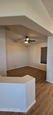 a room with wooden floor and white walls