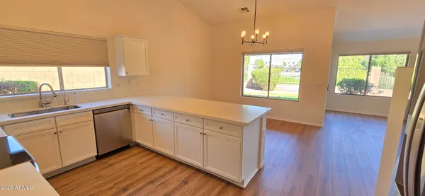 a kitchen with sink cabinets and wooden floor