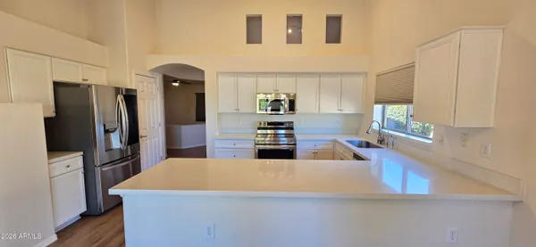 a kitchen with stainless steel appliances a refrigerator and a stove top oven