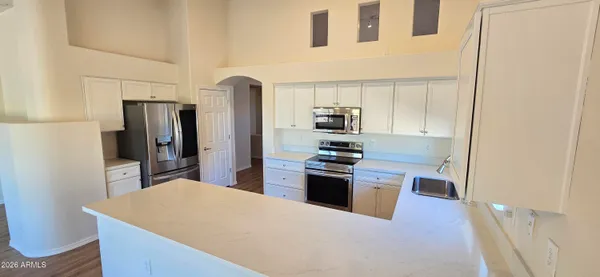 a kitchen with stainless steel appliances a refrigerator stove and oven