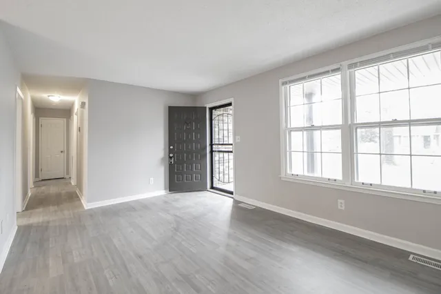 wooden floor in an empty room with a window