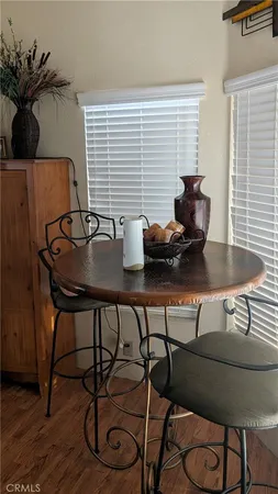 a dining room with furniture and wooden floor
