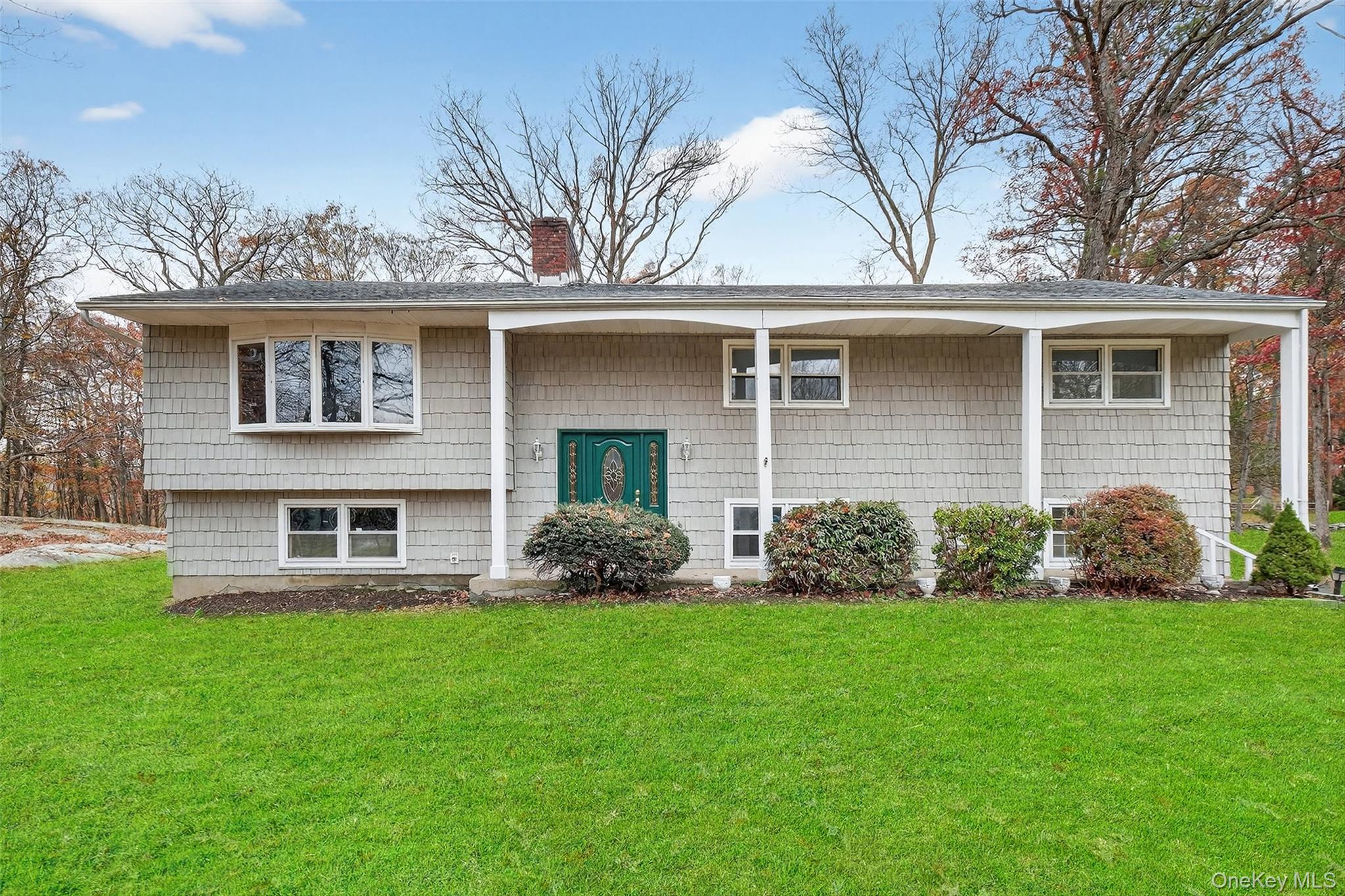 37 Spruce Knolls Road Putnam Valley, NY 10579 - Photo 1 of 1 a front view of a house with a garden and yard