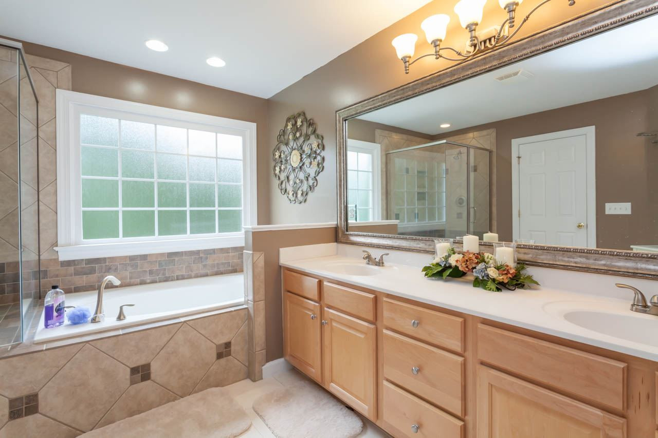8412 Aptos Court Raleigh, NC 27613 - Photo 17 of 25 Dual sink vanity and brand new frosted window. Master Bath