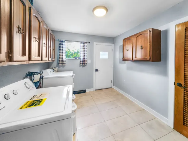 a kitchen with a refrigerator and a sink