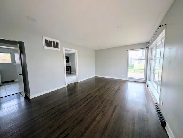 a kitchen with granite countertop a refrigerator stove top oven and sink