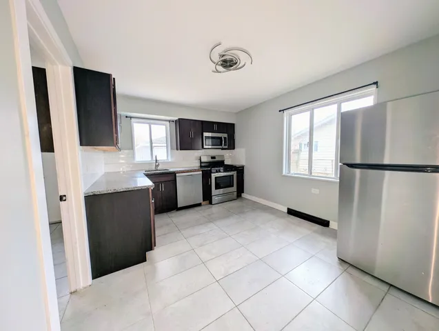 a kitchen with a sink stove and microwave