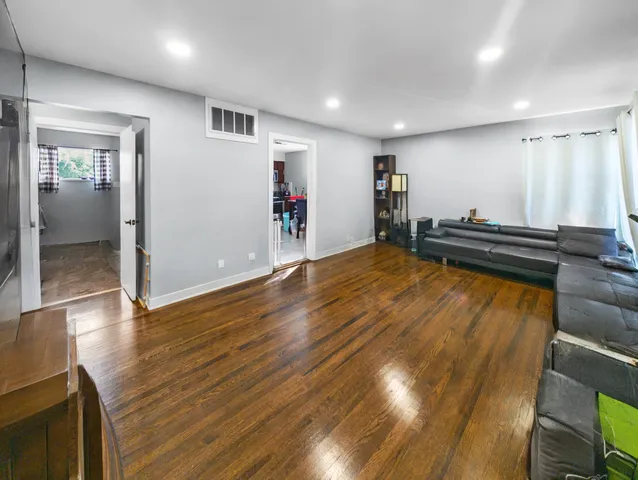 a view of a room with wooden floor