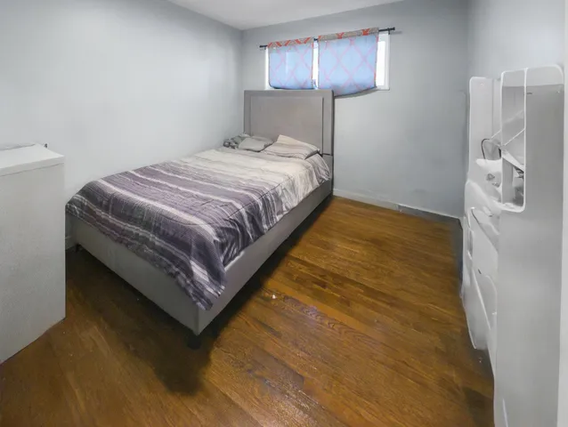 a bedroom with a bed and a lamp on table