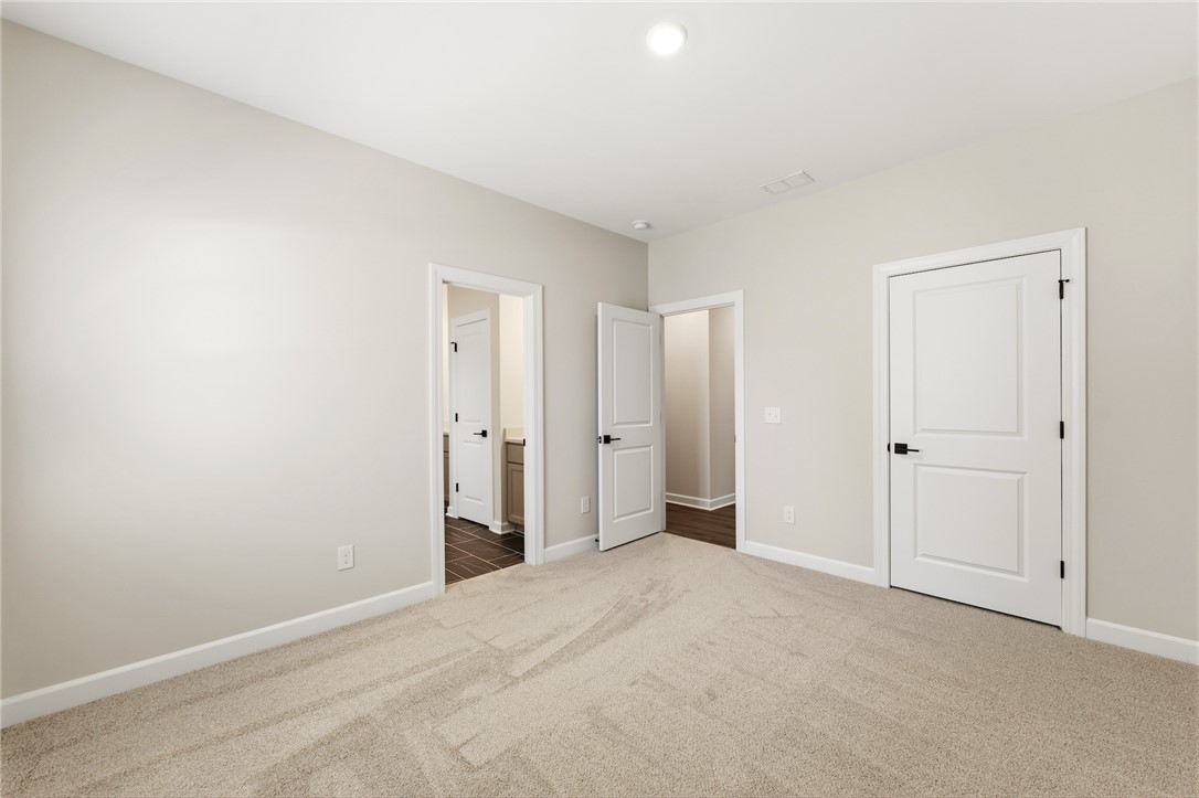 701 Weathered Oak Way Anderson, SC 29621 - Photo 26 of 41 This spacious bedroom offers comfortable carpet flooring and bright recessed lighting.
