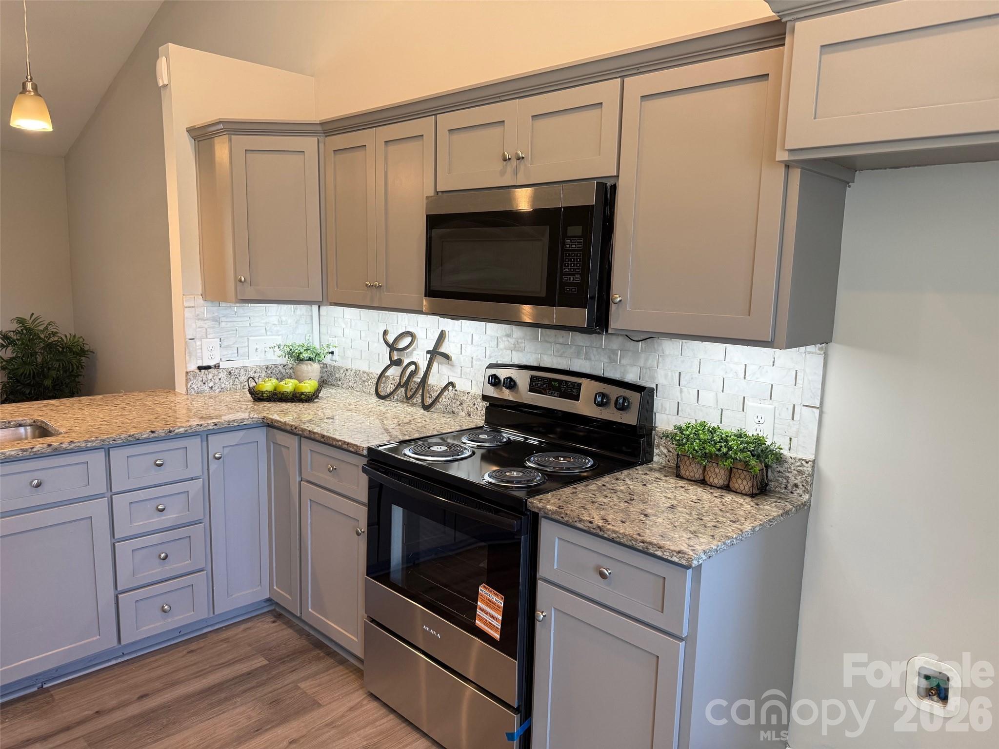 2122 Centergrove Road Kannapolis, NC 28083 - Photo 16 of 47 a kitchen with granite countertop a stove and a sink